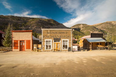 store fronts in an abandoned desert town with mountains in the background