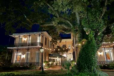 exterior of malaga inn lit up at night