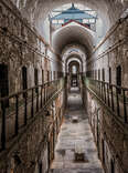 A daytime interior shot of Eastern State Penitentiary, with crumbling walls